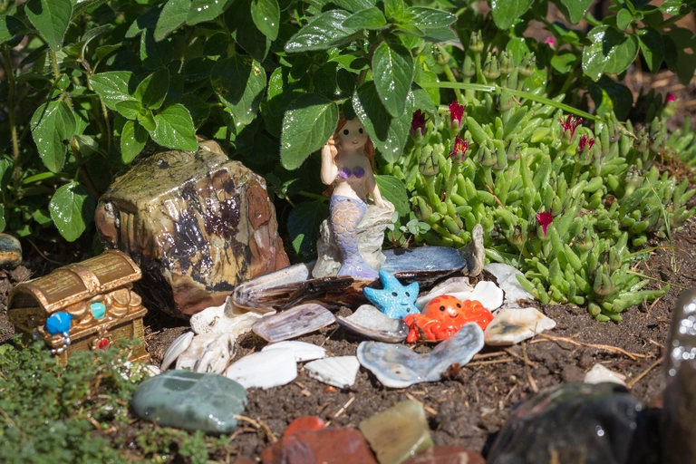 Mermaid fairy garden with shells that represent water.